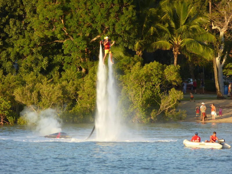 a jet boarder or fly boarder hovering over the water on jets of water