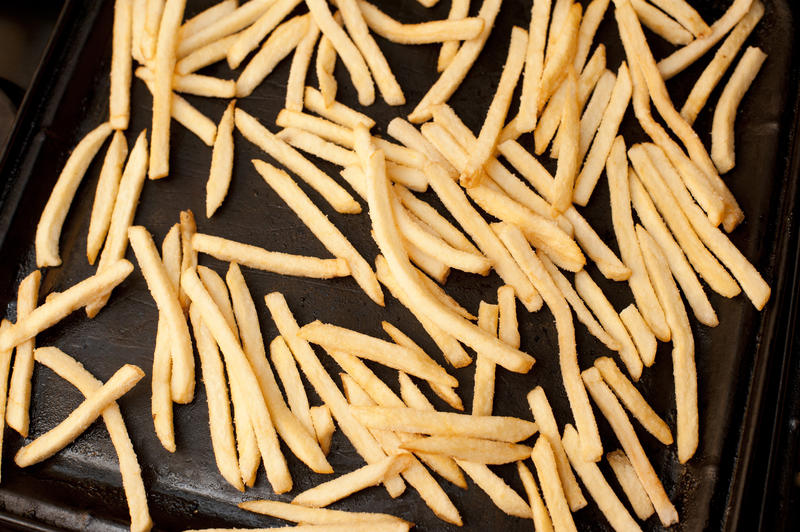 French fries on an oven tray ready to be baked in the oven for a healthy vegetable accompaniment