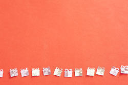 11406   Silver Gift Confetti in a Row on Orange Background