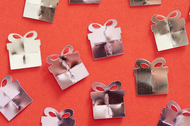 concept image of a party gift shower with silver coloured presents on a red background for good luck