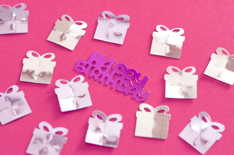 Pink background with presents and a birthday message for a girl