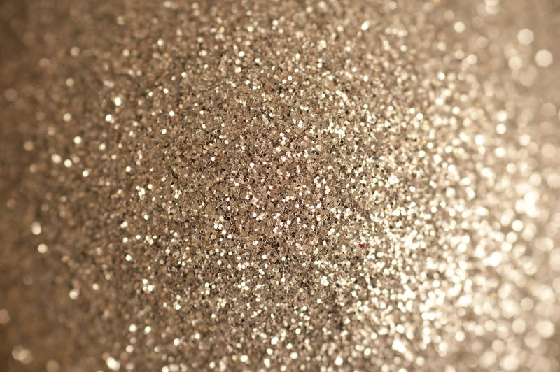 Full Frame Abstract Background of Festive Gold Glitter, Framed with Soft Diffuse Focus Toward Outer Sides of Image