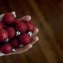 11690   Man holding a handful of Christmas baubles