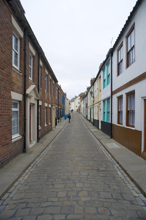 Cobble stoned Henrietta Street in Whitby lined with cottages