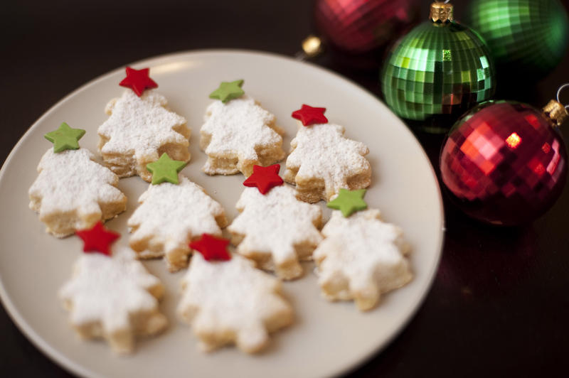 Tasty golden Christmas cookies in the shape of Christmas trees home baked to celebrate the festive Xmas holiday