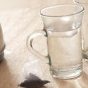 11601   Tea Bag on Wooden Table Next to Mug of Hot Water