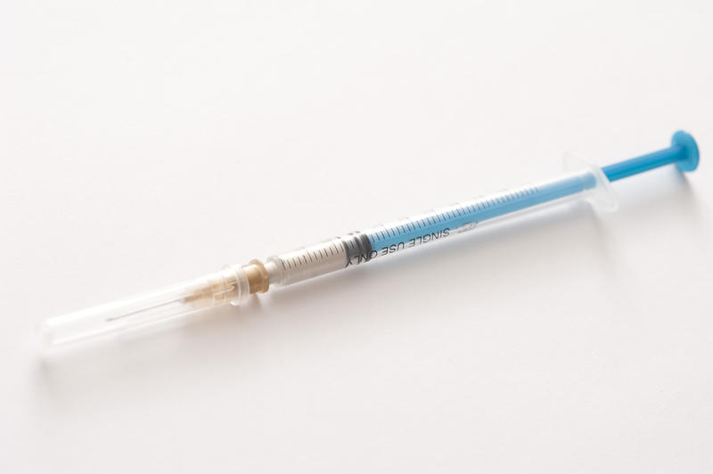 Small disposable plastic hypodermic syringe and injection needle for administering subcutaneous or intramuscular drugs