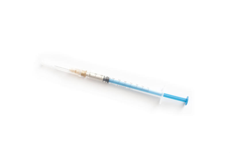 High Angle View of Single Syringe Filled with Medication Injection on White Background with Ample Copy Space