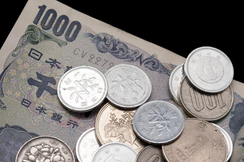Close up financial and banking background of 1000 Japanese yen banknotes and assorted coins