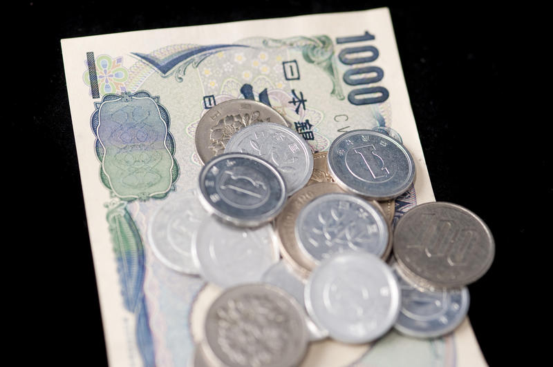 Currency Concept - Japanese Yen - Close up Coin and Paper Money Bills Isolated on Black Background