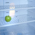 8133   One green apple inside a fridge
