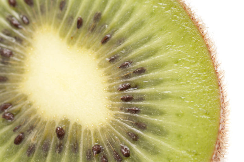Close up texture of a fresh sliced kiwifruit showing the succulent sweet juicy flesh and pattern of pips