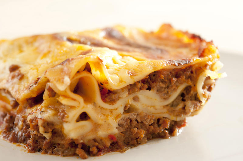 Close up Appetizing Homemade Lasagne Food on White Plate with White Background.