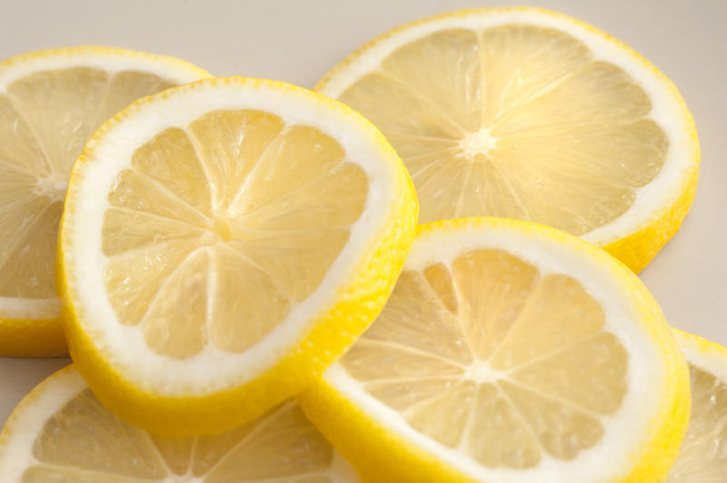 Close-up of several segments of lemon lying on table