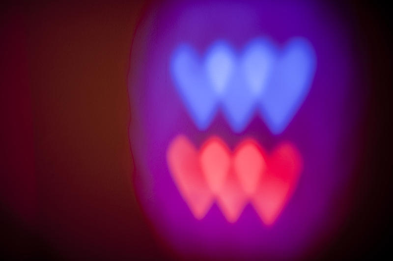 red and blue colourd heart shapes painted with light on a dark background