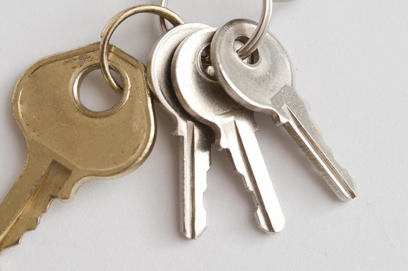 Security Concept - Close up Luggage Keys on a Ring , on Off White Background.