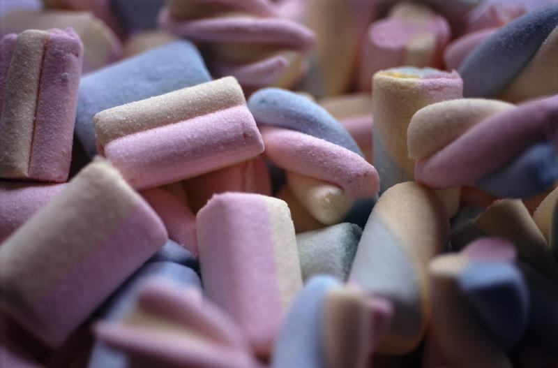 Background of colouful soft spongy marshmallow candy with shallow dof
