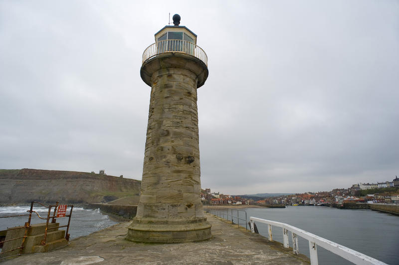 A navigation lighthouse on a stone pier