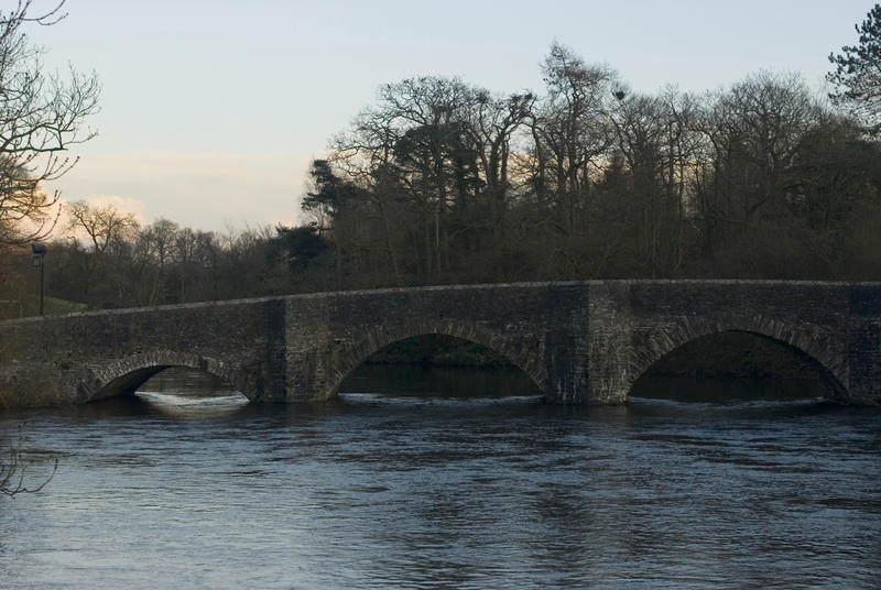 A picturesque sunset view of the arched stone Newby Bridge in Cumbria which lends its name to the popular hamlet of Newby Bridge close by