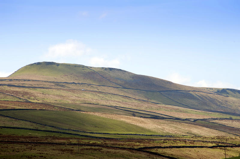 North Yorkshire Dales with its characteristic scenery of green upland pastures separated by dry-stone walls on rolling hills