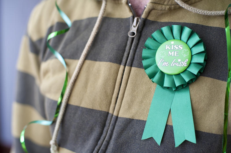 a person wearing a novelty st patricks day ribbon with kiss me message on it