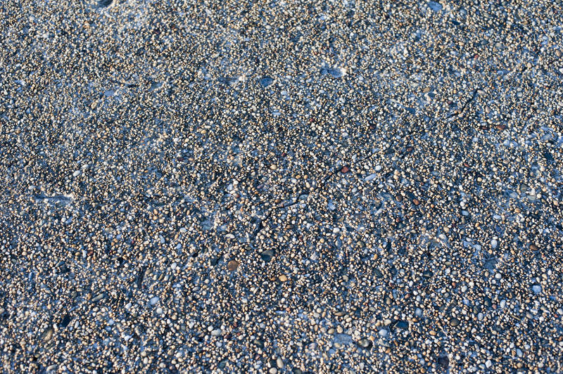 textured surface of concrete acid washed with smooth stones embedded