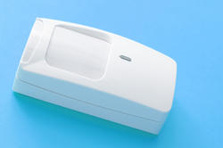 11113   White PIR Detector Isolated on Sky Blue Background