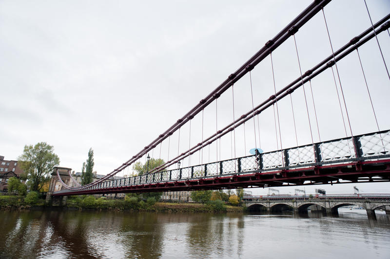 Span detail of the steel construction of the South Portland Street Suspension Bridge over the River Clyde in Glasgow showing the cables and supports