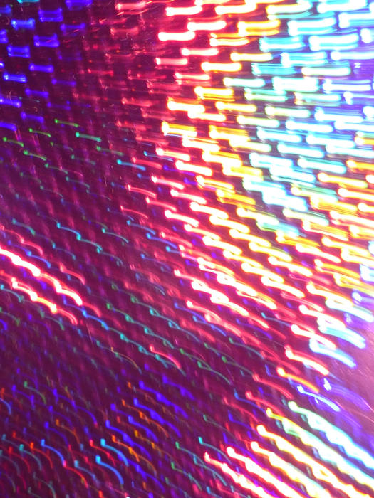 a shimmering array of motion streaks zooming away from the camera in all colours of the spectrum