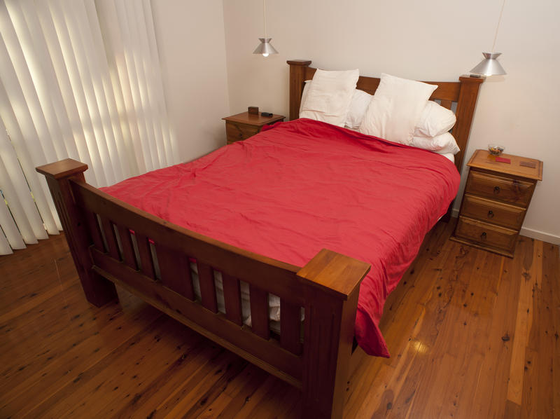 Free Stock Photo 8938 Classic wooden bed with a red bedspread