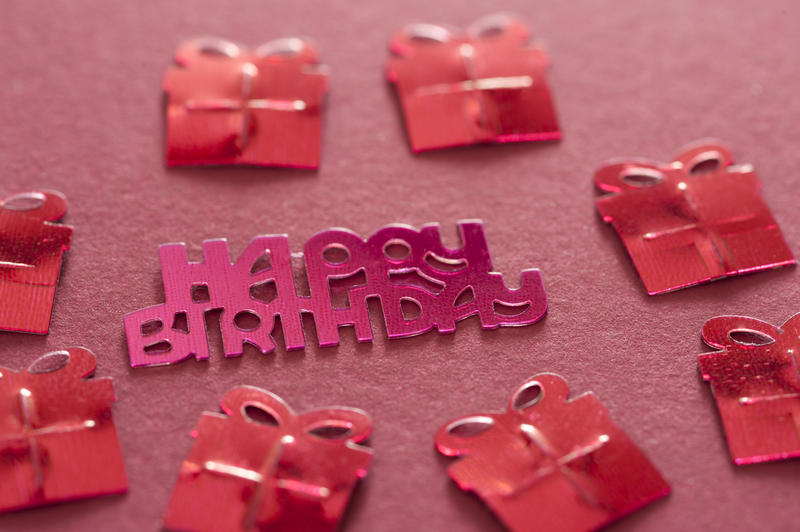happy brithday and red coloured gift or present shapes on a red background