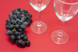 11659   Grapes on Red Background with Empty Wine Glasses