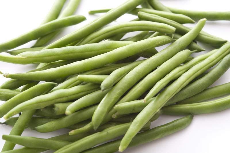 Pile of green beans on white background