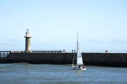 8026   j92 Yacht sailing past Whitby breakwaters