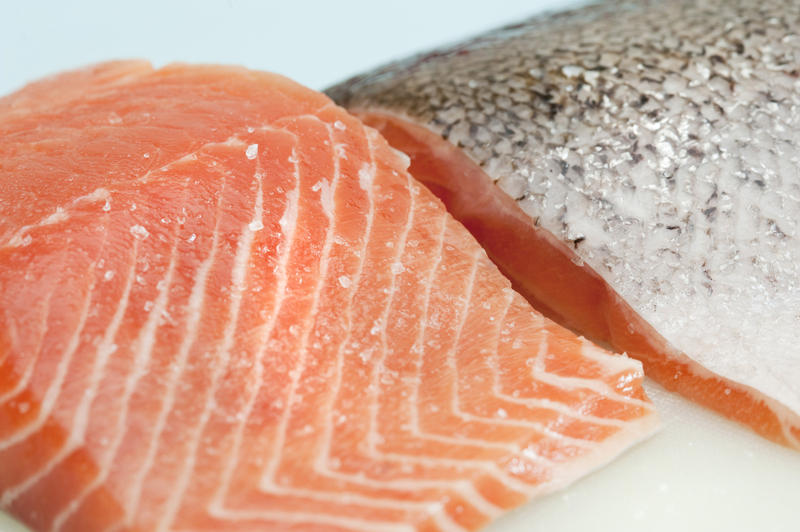 Fresh salmon steak textures with two fillets, one with the succulent flesh uppermost and the second showing the skin