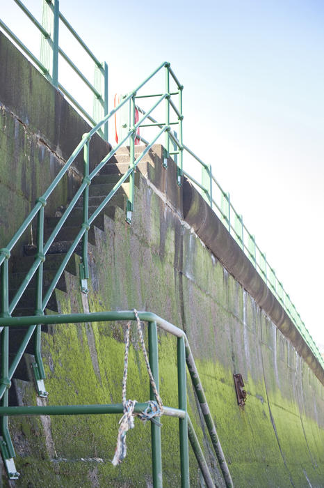 Low angle view of the high concrete structure and flight of steps of the Sandsend sea wall providing protection from the action of the waves and erosion