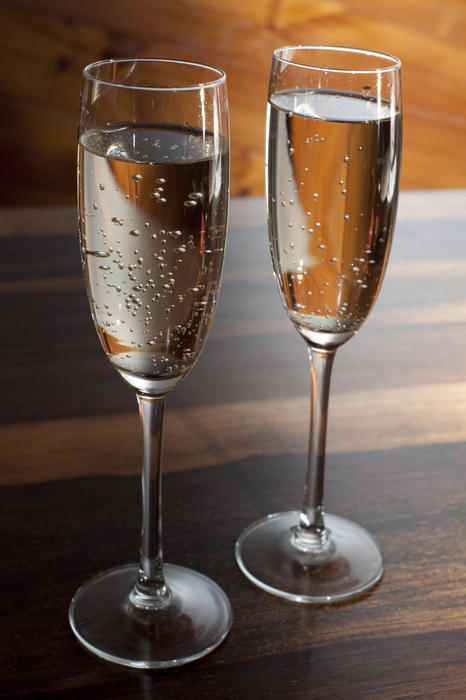 Two flutes of sparkling white wine or bubbly champagne for a romantic celebration, wedding or anniversary to drink the toasts