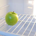 8287   Single green apple inside a fridge