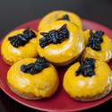 8548   Plate of colourful orange spider doughnuts