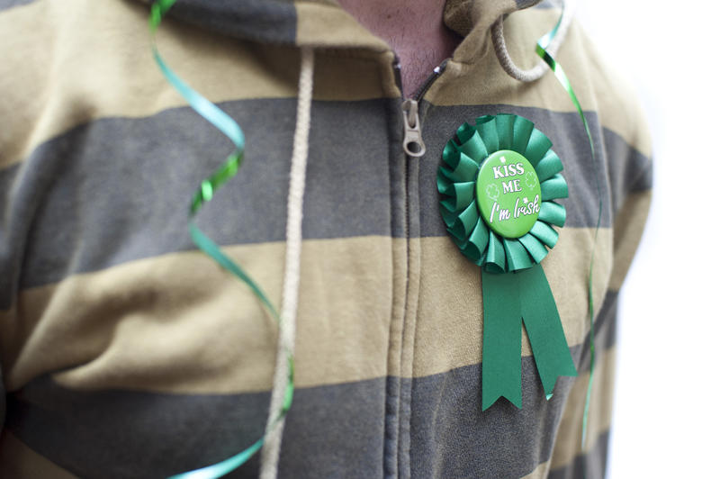 st patricks day party concept, a man with streamer and novelty button