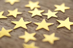 11202   Gold Stars Scattered on Wooden Surface