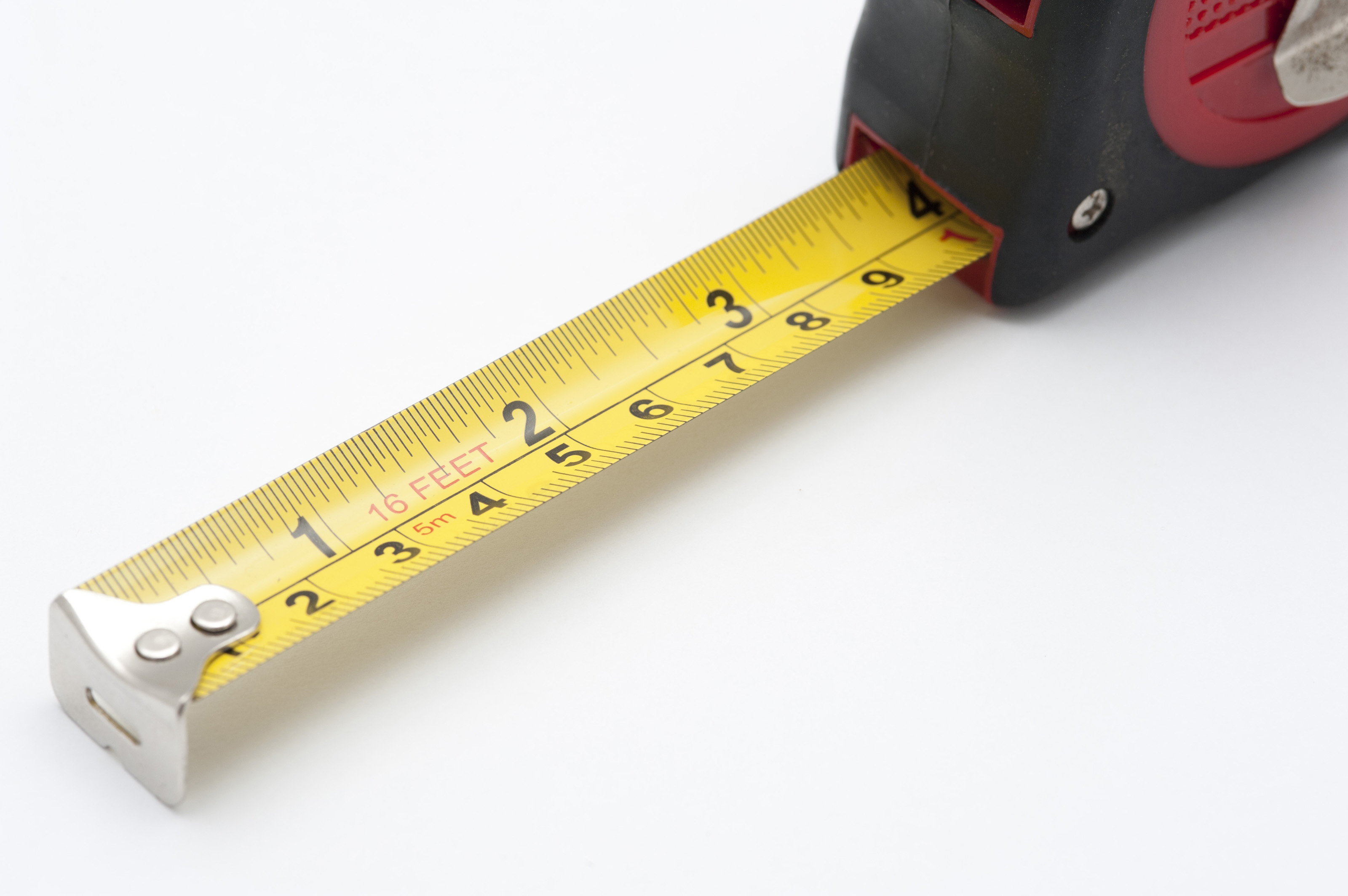 Free Stock Photo 10183 Self Retracting Yellow Measuring Tape On White Free Stock Photo 10183 Self Retracting Yellow Measuring Tape On White