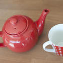 10598   Red Teapot and a Cup on a Wooden Table