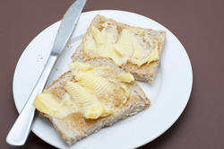 10629   Tasty Toasted Bread with Butter on White Plate