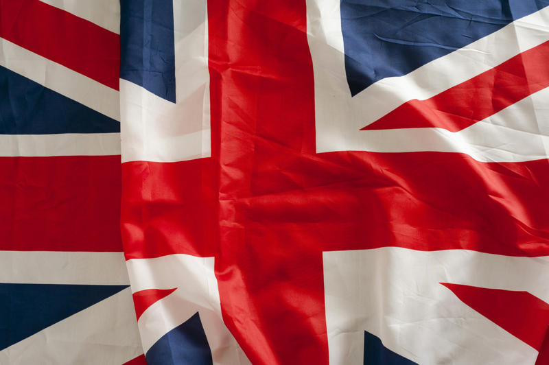 Background pattern and texture of a Union Jack, or Union Flag, of the United Kingdom with a single fold and creases in the fabric