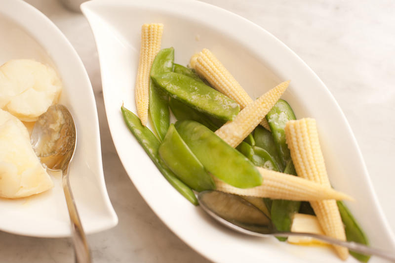 Vegetable side plate with mangetout peas and miniature corn on the cob for a tasty healthy acoompaniment to a meal