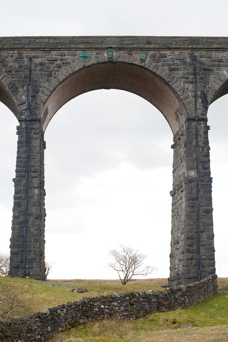 Stone arch on the Ribblehead Viaduct a curved stone Victorian railway viaduct crossing the River Ribble in North Yorkshire