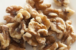 11813   Close Up of Shelled Walnuts on White Background