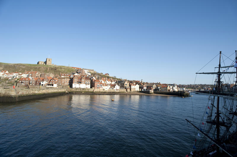 View across the water of the River Esk and harbour towards Tate Hill and St Marys Church in Whitby on the Yorkshire coast