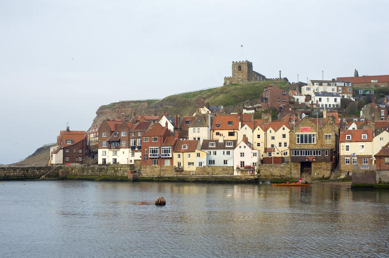Tate Hill and St Marys Church with the picturesque cottages on the Whitby waterfront in the Lower Harbour below